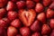 love and food concept - close up of heart shaped strawberry background