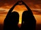 Love, freedom and heart sign by couple silhouette of lesbian and lgbt pride, hand shape at sunset. Women celebrate