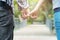 Love and friendship concept. man and young woman hold on to little fingers in public park background. Couple hands hook