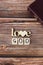 Love God text written with wooden cubes and letters with heart shape on rustic background with Holy Bible Book, vertical shot