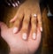 Love hands of an ethnic black and White couple during Valentine& x27;s day in a restaurant.  Ring would you like to marry me ?