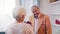 Love and happines. Elderly man giving red roses to his wife on Valentinces day