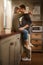 Love, happy and couple hug in kitchen for bonding, loving relationship and relax together in home. Marriage, morning and