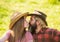 Love and harmony. Bearded cowboy in hat kissing adorable girlfriend. Couple in love. Romantic kiss. Happy couple ranch