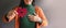 Love, Health Care, Donation and Charity Concept. Close up of Smiling Volunteer Woman Holding a Heart Shape with Cross Sign Paper.