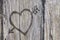 Love heart and arrow graffiti carved into wood