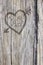 Love heart and arrow graffiti carved into wood