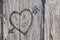 Love heart and arrow graffiti carved into wood