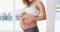 Love, heart hands and fitness with stomach of pregnant woman for training, workout and wellness. Exercise, happy and