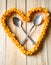 Love heart from orange peels with crossed spoons