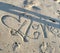 Love and a heart written in the sand.