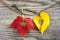 Love hearts on colorful autumn leaves with wooden background.