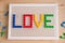 Love inscription with mosaic elements. Valentine`s Day greeting