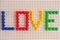 Love inscription with mosaic elements. Valentine`s Day greeting