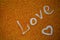 Love inscription on multicolored sand