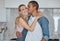 Love, interracial and couple kiss in kitchen, happiness and loving together for relationship. Romance, man and woman