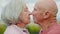 Love, kiss and senior couple in a park happy, free and bonding in nature together. Face, romance and old people in a