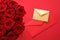 Love letter and flower delivery service on Valentines Day, luxury bouquet of red roses and card envelopes on red background