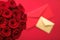 Love letter and flower delivery service on Valentines Day, luxury bouquet of red roses and card envelopes on red background