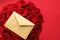 Love letter and flower delivery service on Valentines Day, luxury bouquet of red roses and card envelopes on red background