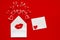 Love letter with a kiss for valentines day. envelope with hearts and female lips on a red background