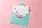 Love letter with red hearts. Blank template with place for text on postcard. Green envelope on pink background. mock-up