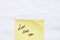 Love lives here handwriting text close up isolated on yellow paper with copy space