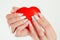 Love for manicure art concept. Beauty hands holding red heart shaped jewelry box. Stylish pastel Color pink coral white Nails