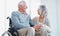 Love means being there for each other no matter what. a senior man in a wheelchair being cared for by his wife.