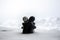 Love melts the ice Valentine `s day concept. F girl and a boy dolls hugs each other, standing on the white snow with blurred backg