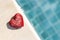 Love message on red heart with space on blurred blue swimming pool water background