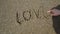 Love message written in sand.