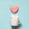 Love. Pink lollipops on stick with Love text in cup with marshmallow on blue. Copy space
