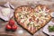 Love pizza. Baked heart-shaped homemade pizza