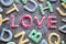 Love in red icing amongst letter shaped cookies, close-up