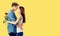 Love, relationship, dating, flirting, romantic - hugging couple with flower. yellow background. copy space