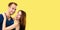 Love, relationship, dating, flirting, romantic - Smiling happy amazed couple. yellow background. copy space