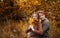 Love, relationship, family and people concept - close up of couple with maple leaf in autumn park