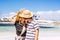 Love and relationship people - happy young couple kiss eachother on vacation lifestyle - blue sea and sky in background with