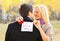 Love, relationships, engagement and wedding concept - man proposes a woman to marry, red box ring, happy smiling romantic couple