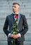 love rendezvous concept. adult tuxedo man with love rose. flower gift for love day