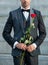 love rendezvous concept. cropped view of tuxedo man with love rose. flower present for love day