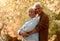 Love, romance and old couple hug in garden, happy in retirement. Nature, summer and senior man and woman hugging
