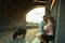 Love and romantic concept. Couple in love with sunset stand by the wall kiss and hug under the bridge next to motorcycle