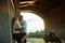 Love and romantic concept. Couple in love with sunset stand by the wall kiss and hug under the bridge next to motorcycle