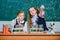 We love science. School children performing experiment in science classroom. Little girls scientists holding test tubes