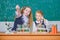 We love science. School children performing experiment in science classroom. Little girls scientists holding test tubes