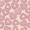 Love seamless pattern with pink heart cookies