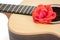 Love song. Red rose on acoustic guitar. Romantic music concept