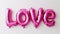 LOVE Spelled Out in Pink Metallic Balloons. Generative ai